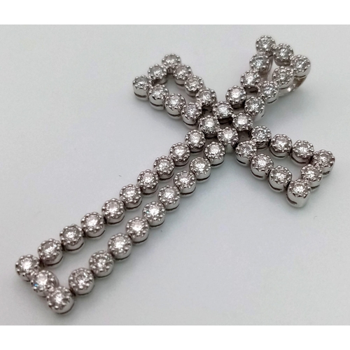 114 - An 18K White Gold Diamond Cross Pendant. 5ct of exceptional bright round-cut diamonds create a heave... 