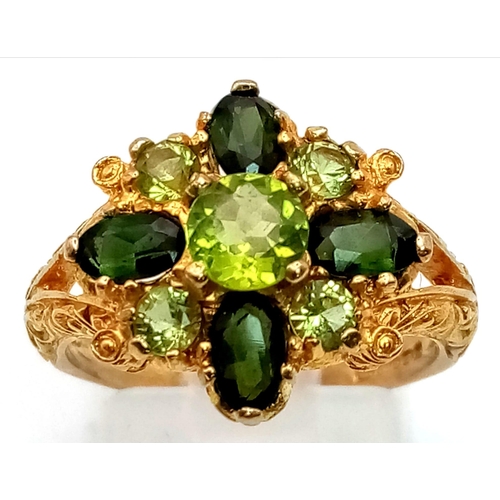 150 - A 9K Yellow Gold High-Georgian-Styled Peridot and Tourmaline Ring. Shades of green for this regal-es... 