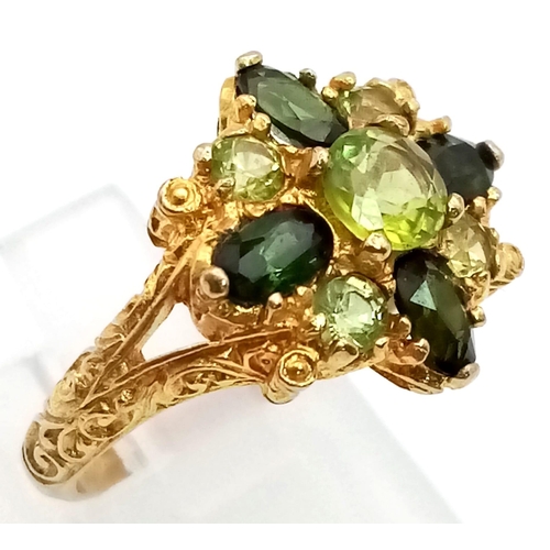 150 - A 9K Yellow Gold High-Georgian-Styled Peridot and Tourmaline Ring. Shades of green for this regal-es... 