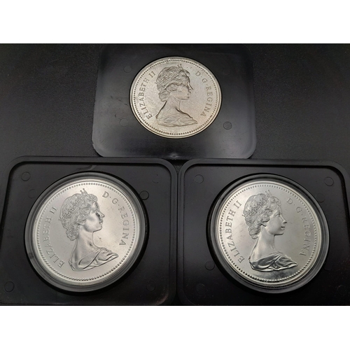 521 - Three Uncirculated Canadian Silver Dollars in Original Presentation Cases.