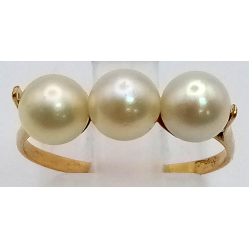 522 - A High K Gold (tested) Three Pearl Ring.
Size P. 2g total weight.