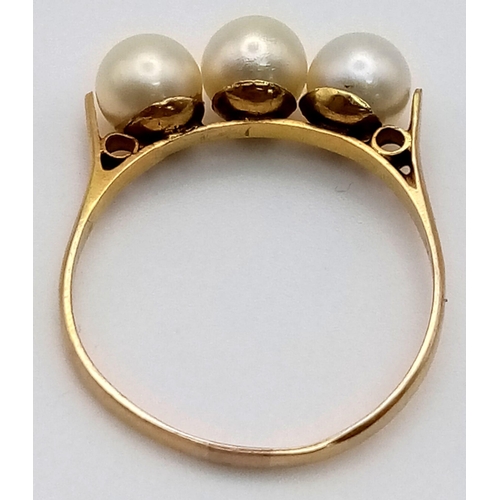 522 - A High K Gold (tested) Three Pearl Ring.
Size P. 2g total weight.