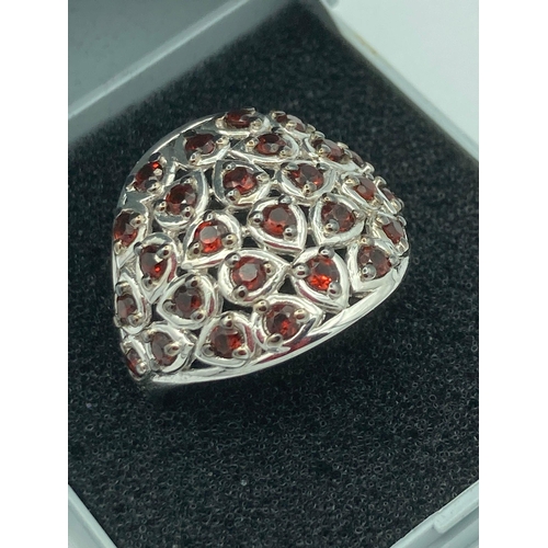 119 - Stunning SILVER RING cluster set with Garnet red gemstones . Complete with ring box. Size R 1/2 - S.