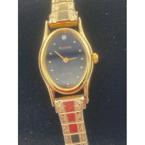 133 - Ladies ACCURIST Quartz wristwatch in gold tone , having oval black face with diamond point at 12 o’c... 