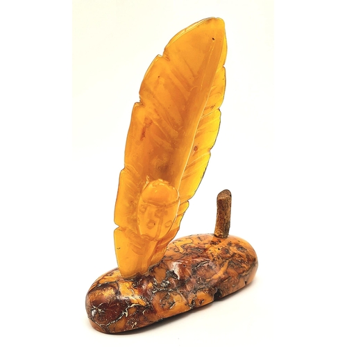 23 - An Antique Large Amber Figure. Polish in origin, this piece has a polished raw amber base with a hon... 