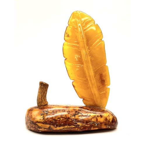 23 - An Antique Large Amber Figure. Polish in origin, this piece has a polished raw amber base with a hon... 