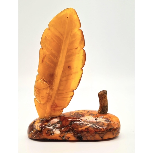 23 - An Antique Large Amber Figure. Polish in origin, this piece has a polished raw amber base with a hon... 