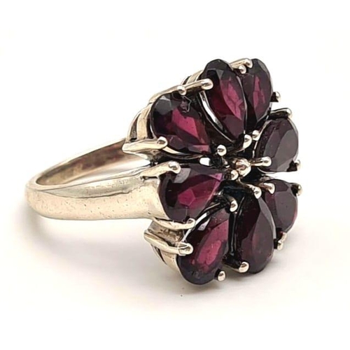 276 - A Vintage Natural Garnet and Silver Ring. Eight garnet petals. Size P. 8.2g total weight.