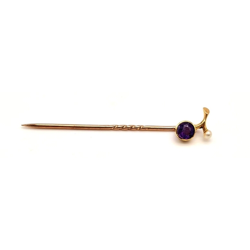 529 - An Antique Victorian High Gold K Amethyst and Seed Pearl Stick Pin. 5cm.