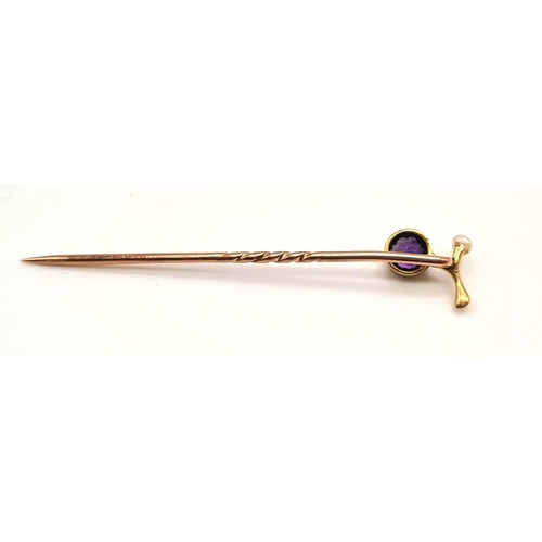 529 - An Antique Victorian High Gold K Amethyst and Seed Pearl Stick Pin. 5cm.