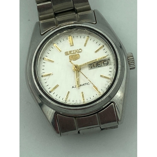 63 - Ladies SEIKO 5 AUTOMATIC WRISTWATCH in Silver Tone. Day/Date model having golden digits and hands. F... 