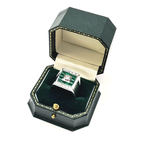 71 - A Heavy 18k White Gold Emerald and Diamond Dress Ring. Central round-cut brilliant diamonds surround... 