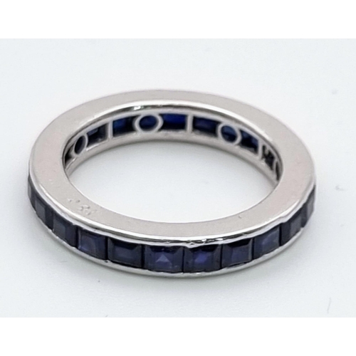 279 - An 18K White Gold Sapphire Full-Eternity Ring. Twenty-four square-cut natural blue sapphires. Size R... 