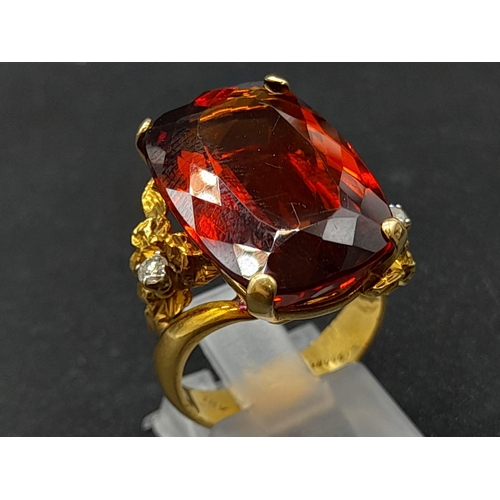 39 - An 18K Yellow Gold Amber Citrine and Diamond Ring. A large cushion mixed-cut natural citrine and two... 