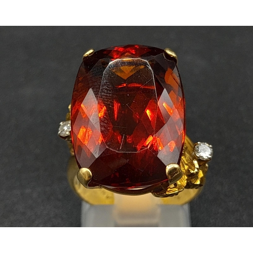 39 - An 18K Yellow Gold Amber Citrine and Diamond Ring. A large cushion mixed-cut natural citrine and two... 