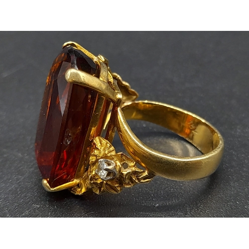 39 - An 18K Yellow Gold Amber Citrine and Diamond Ring. A large cushion mixed-cut natural citrine and two... 