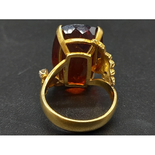 39 - An 18K Yellow Gold Amber Citrine and Diamond Ring. A large cushion mixed-cut natural citrine and two... 