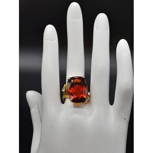 39 - An 18K Yellow Gold Amber Citrine and Diamond Ring. A large cushion mixed-cut natural citrine and two... 