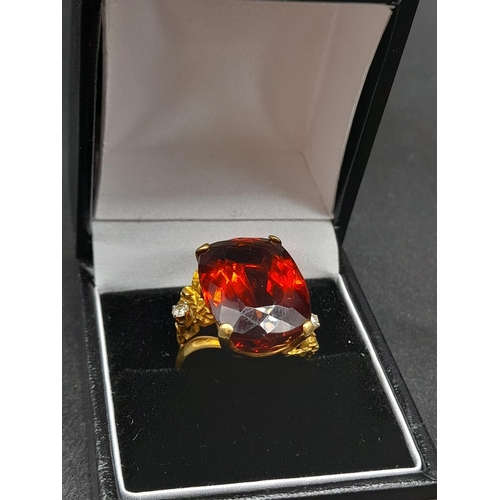 39 - An 18K Yellow Gold Amber Citrine and Diamond Ring. A large cushion mixed-cut natural citrine and two... 