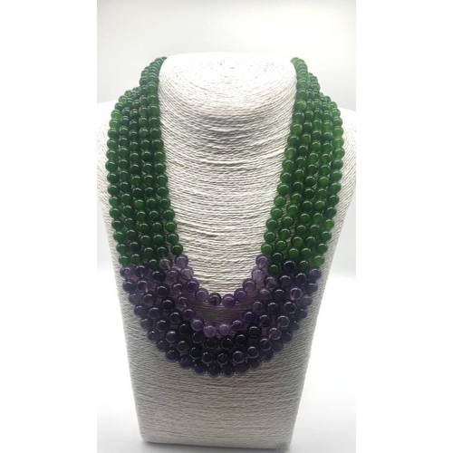 148 - A Statement Amethyst and Jade Beaded Five-Strand Necklace. 42-50cm. 6-8mm beads. Double triangle cla... 