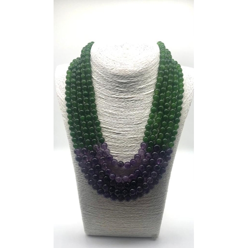 148 - A Statement Amethyst and Jade Beaded Five-Strand Necklace. 42-50cm. 6-8mm beads. Double triangle cla... 