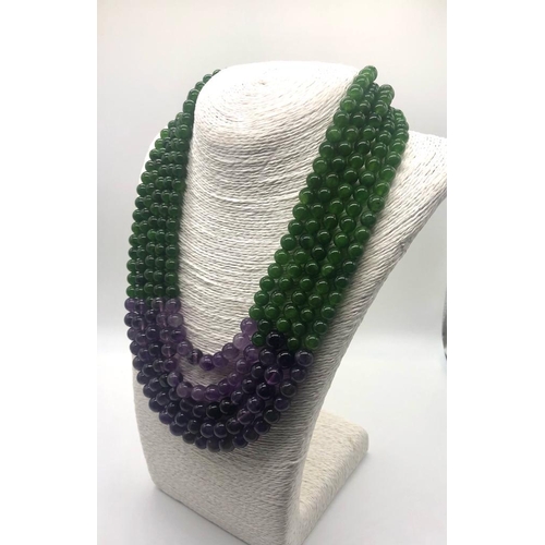 148 - A Statement Amethyst and Jade Beaded Five-Strand Necklace. 42-50cm. 6-8mm beads. Double triangle cla... 