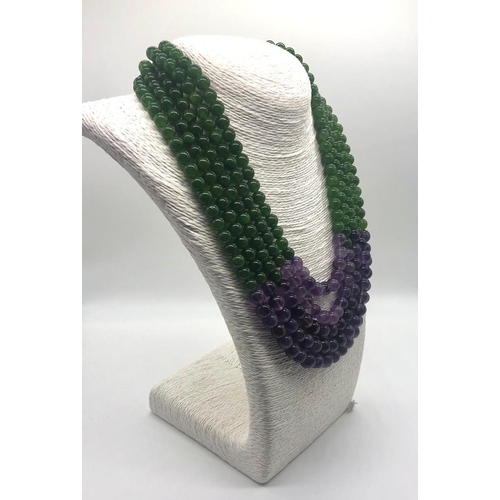 148 - A Statement Amethyst and Jade Beaded Five-Strand Necklace. 42-50cm. 6-8mm beads. Double triangle cla... 