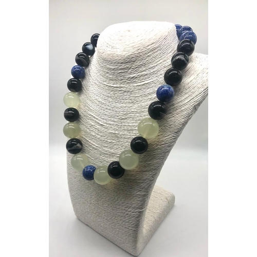 353 - A Lapis Lazuli, Green Chalcedony and Banded Agate Necklace. Beads 15-20mm. Lobster clasp. 50cm. Come... 