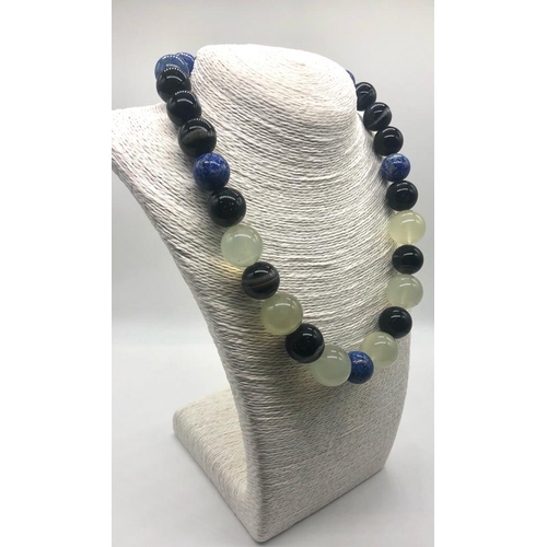 353 - A Lapis Lazuli, Green Chalcedony and Banded Agate Necklace. Beads 15-20mm. Lobster clasp. 50cm. Come... 