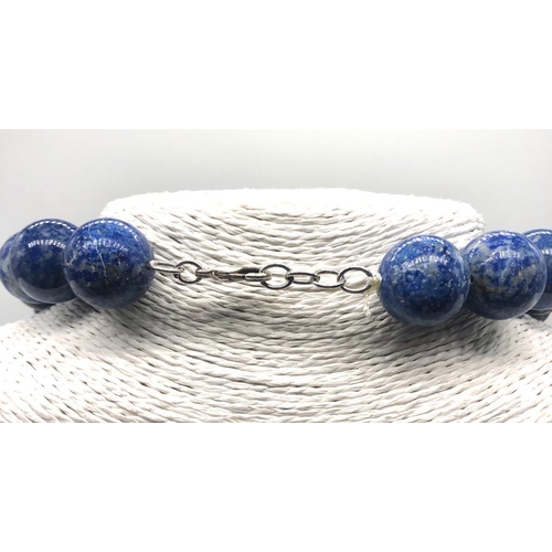 353 - A Lapis Lazuli, Green Chalcedony and Banded Agate Necklace. Beads 15-20mm. Lobster clasp. 50cm. Come... 