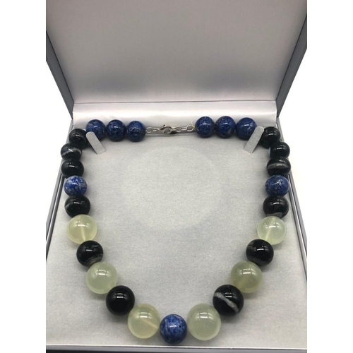 353 - A Lapis Lazuli, Green Chalcedony and Banded Agate Necklace. Beads 15-20mm. Lobster clasp. 50cm. Come... 