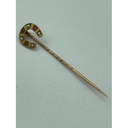 539 - Antique 9 carat GOLD  stick pin having horseshoe to top with Ruby and seed pearl detail.