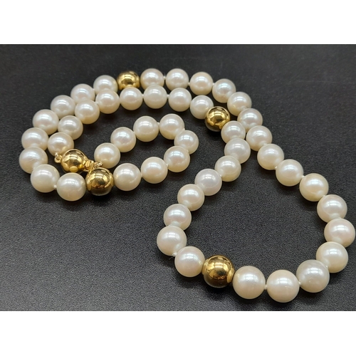 19 - An 18K Yellow Gold Necklace with 48 round Cultured Pearls. 22.59g total weight. Comes with a W.G.I. ... 