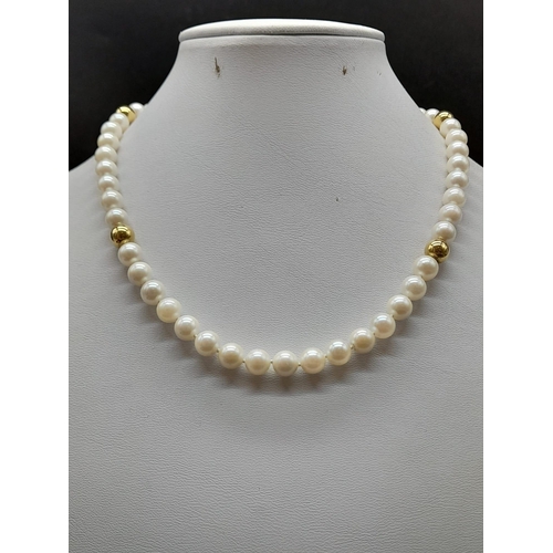 19 - An 18K Yellow Gold Necklace with 48 round Cultured Pearls. 22.59g total weight. Comes with a W.G.I. ... 