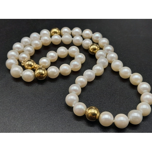 19 - An 18K Yellow Gold Necklace with 48 round Cultured Pearls. 22.59g total weight. Comes with a W.G.I. ... 