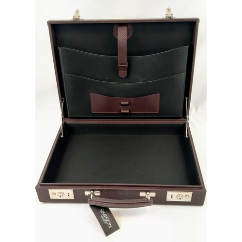 599 - A Simpson of London Carbon Brown Leather Attaché Case. Unused, but some small signs of shop wear and... 