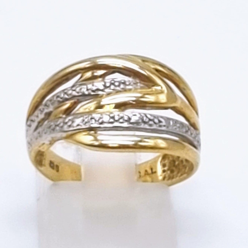 613 - A 9K Yellow and White Gold Intertwining Band Ring. Size O. 3.27g total weight.