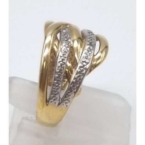 613 - A 9K Yellow and White Gold Intertwining Band Ring. Size O. 3.27g total weight.