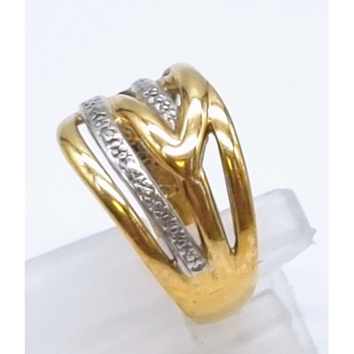 613 - A 9K Yellow and White Gold Intertwining Band Ring. Size O. 3.27g total weight.