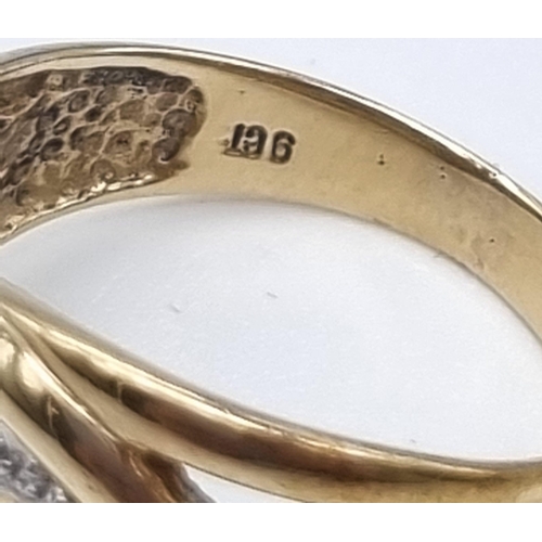 613 - A 9K Yellow and White Gold Intertwining Band Ring. Size O. 3.27g total weight.