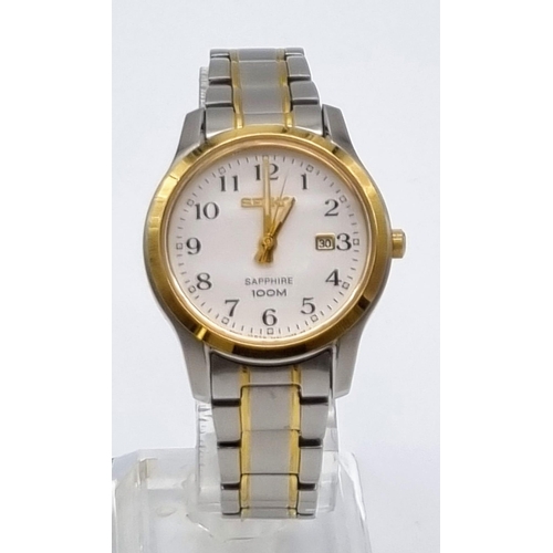 621 - A Seiko Sapphire Ladies Quartz Watch. Two tone strap and case - 28mm. White dial with date window. I... 