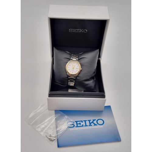 621 - A Seiko Sapphire Ladies Quartz Watch. Two tone strap and case - 28mm. White dial with date window. I... 