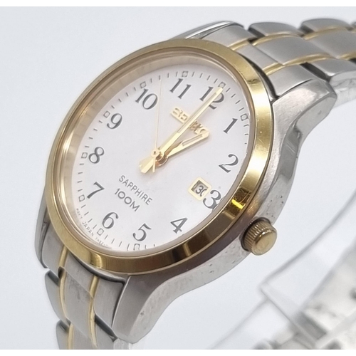 621 - A Seiko Sapphire Ladies Quartz Watch. Two tone strap and case - 28mm. White dial with date window. I... 