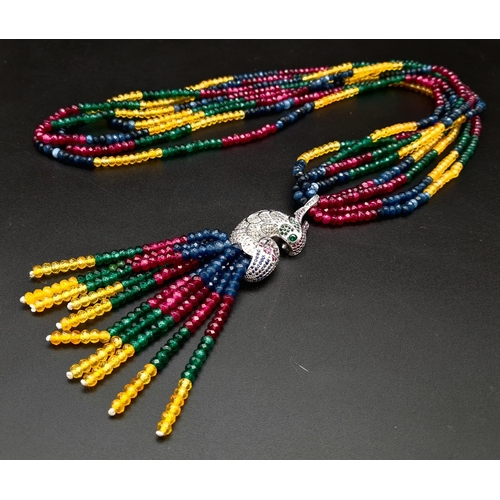 119 - A spectacular four strand necklace with rubies, emeralds, sapphires, citrine and a glorious exotic p... 