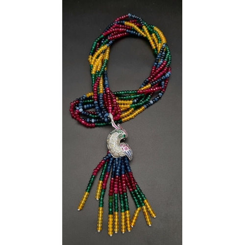 119 - A spectacular four strand necklace with rubies, emeralds, sapphires, citrine and a glorious exotic p... 