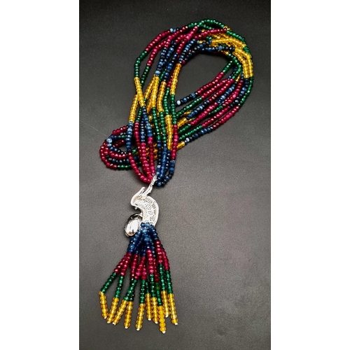 119 - A spectacular four strand necklace with rubies, emeralds, sapphires, citrine and a glorious exotic p... 