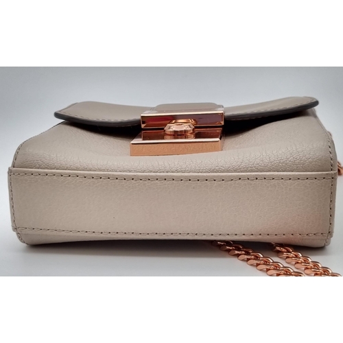 441 - A Ted Baker Leather Handbag. Rose gold plated hardware and strap. Very good condition but please see... 