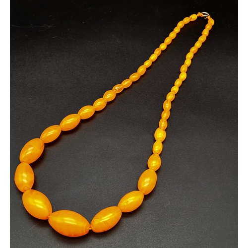 42 - A Vintage Honey-Amber Graduated Bead Necklace. 20mm largest bead. 46cm. 51.35g total weight.