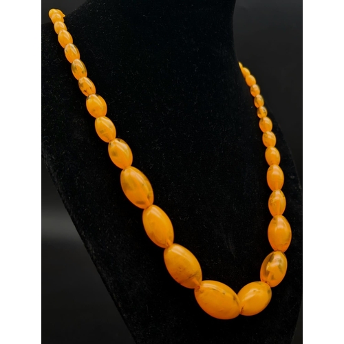 42 - A Vintage Honey-Amber Graduated Bead Necklace. 20mm largest bead. 46cm. 51.35g total weight.