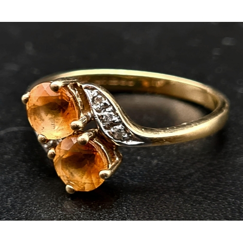 518 - A 9K Yellow Gold Citrine and Diamond Ring. Size K 1/2.
1.68g total weight.